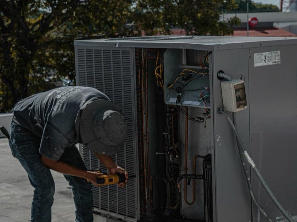 HVAC technician servicing rooftop equipment